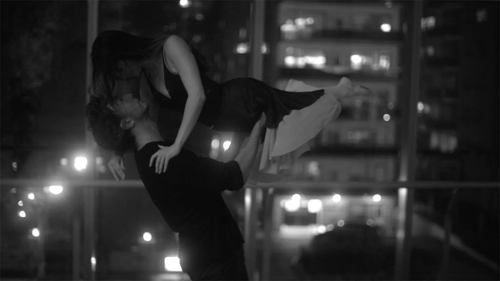 Film still: Kealan McLaughlin performing a lift in a choreographed duet